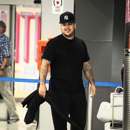 Rob Kardashian caught on a camera in a black t-shirt.